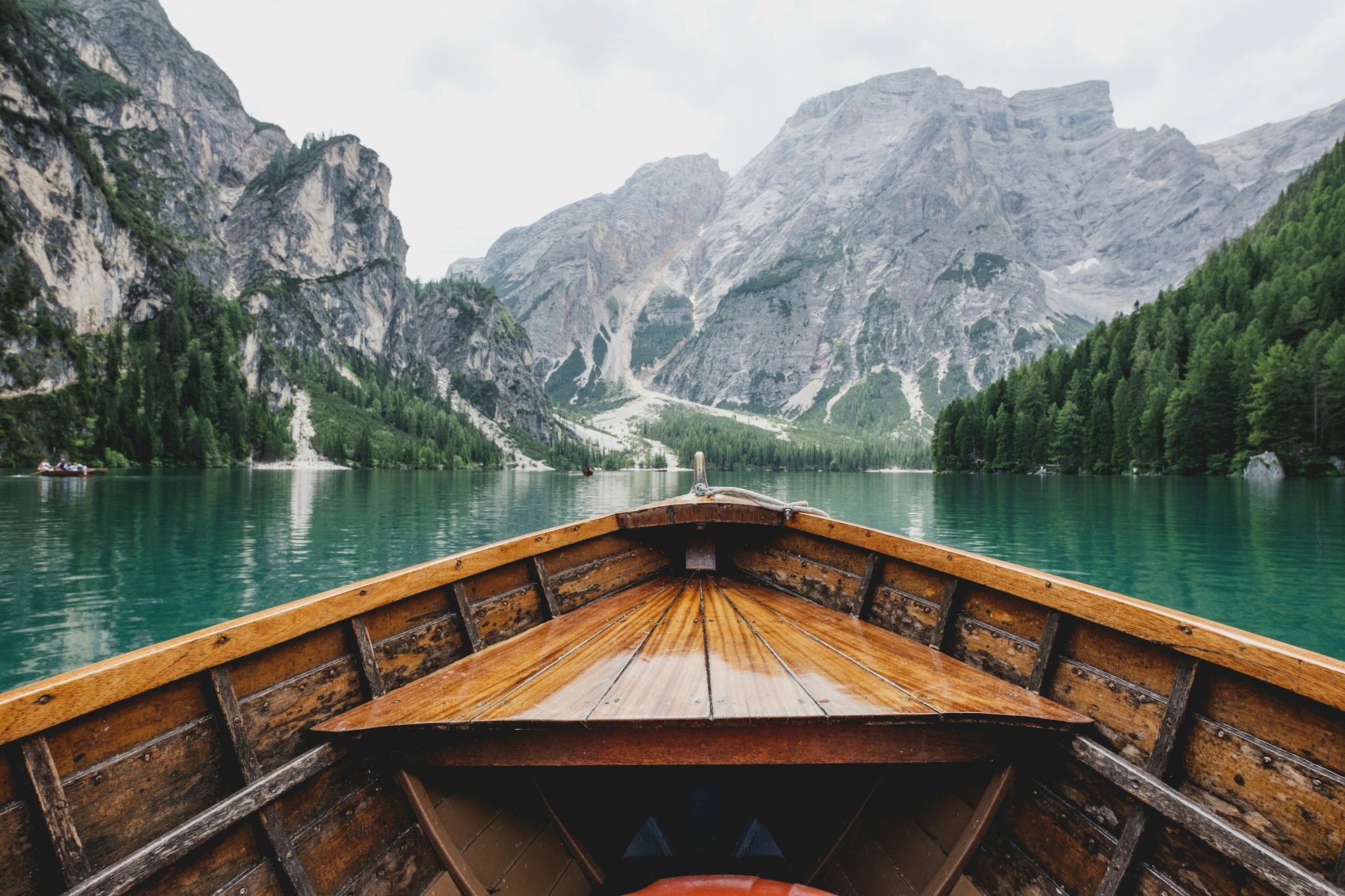 A wooden boat looking out over a mountain lake